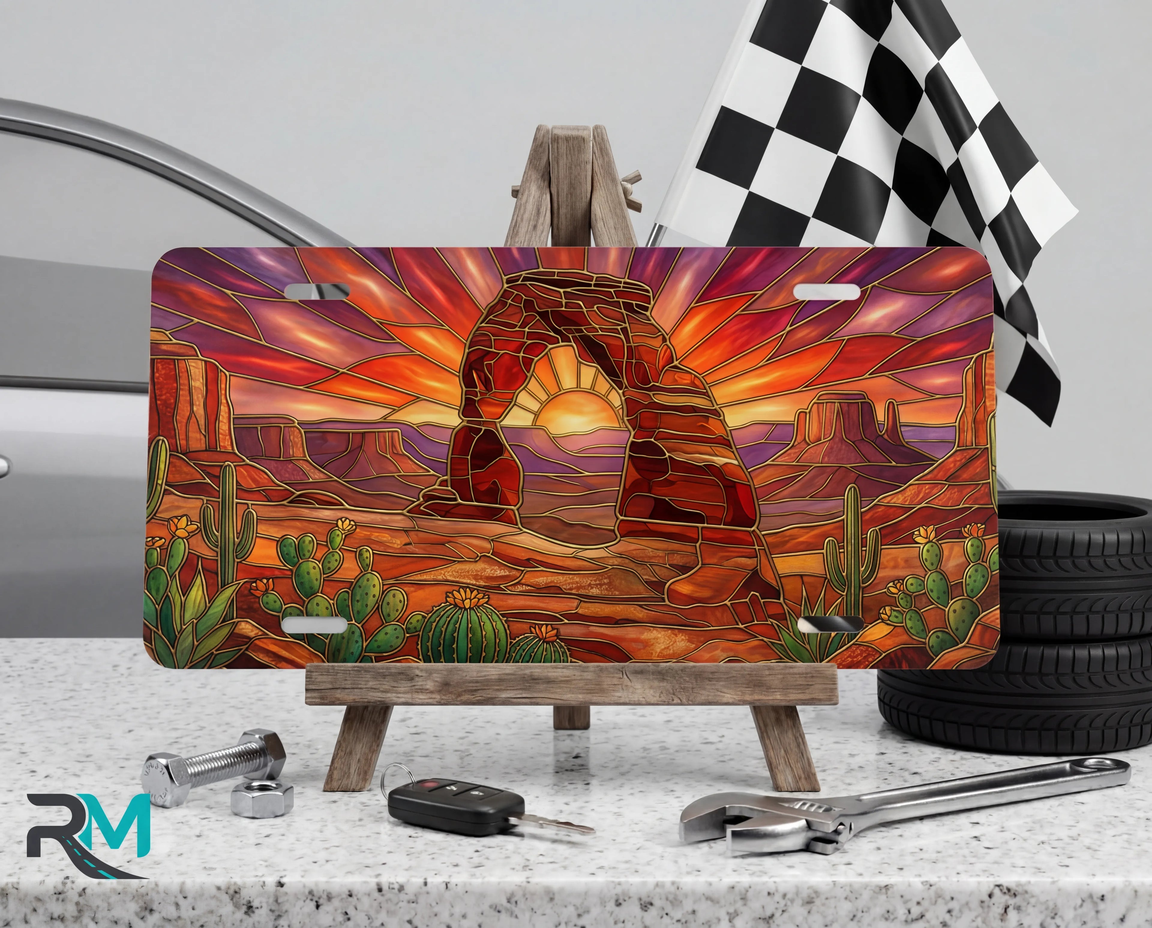 desert arch sunset cactus vanity plate on tire — warm amber southwestern arch scenic front license plate