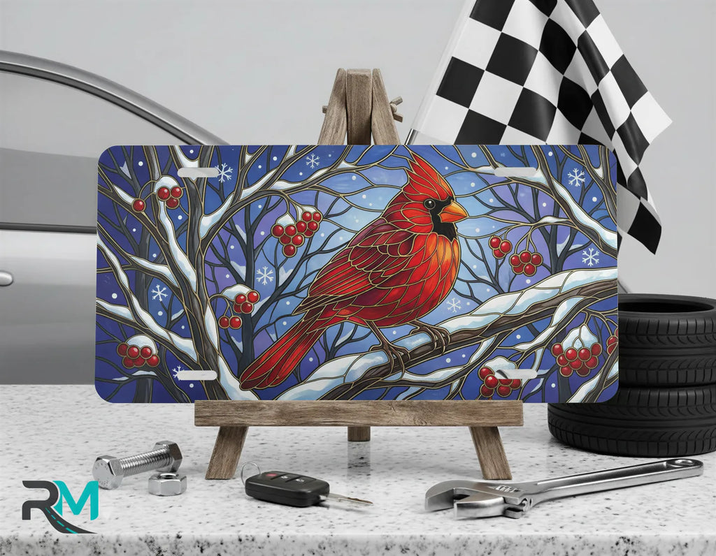 cardinal vanity plate on display stand — vivid scarlet red winter bird aluminum plate
