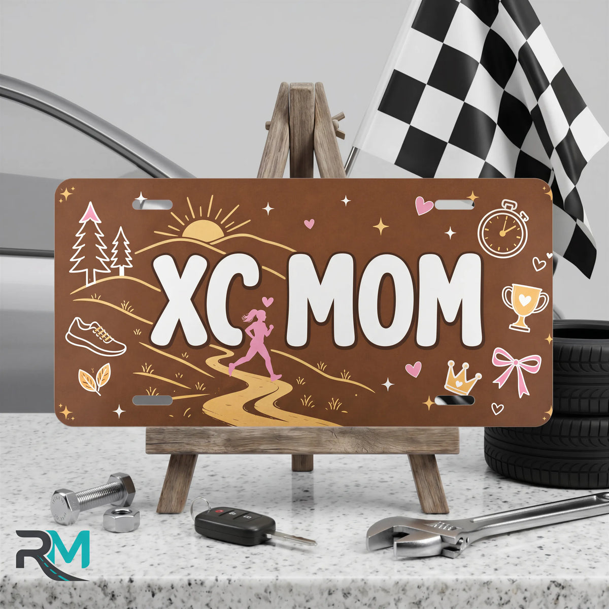 xc mom vanity plate on display stand — earthy sunrise trail aluminum plate