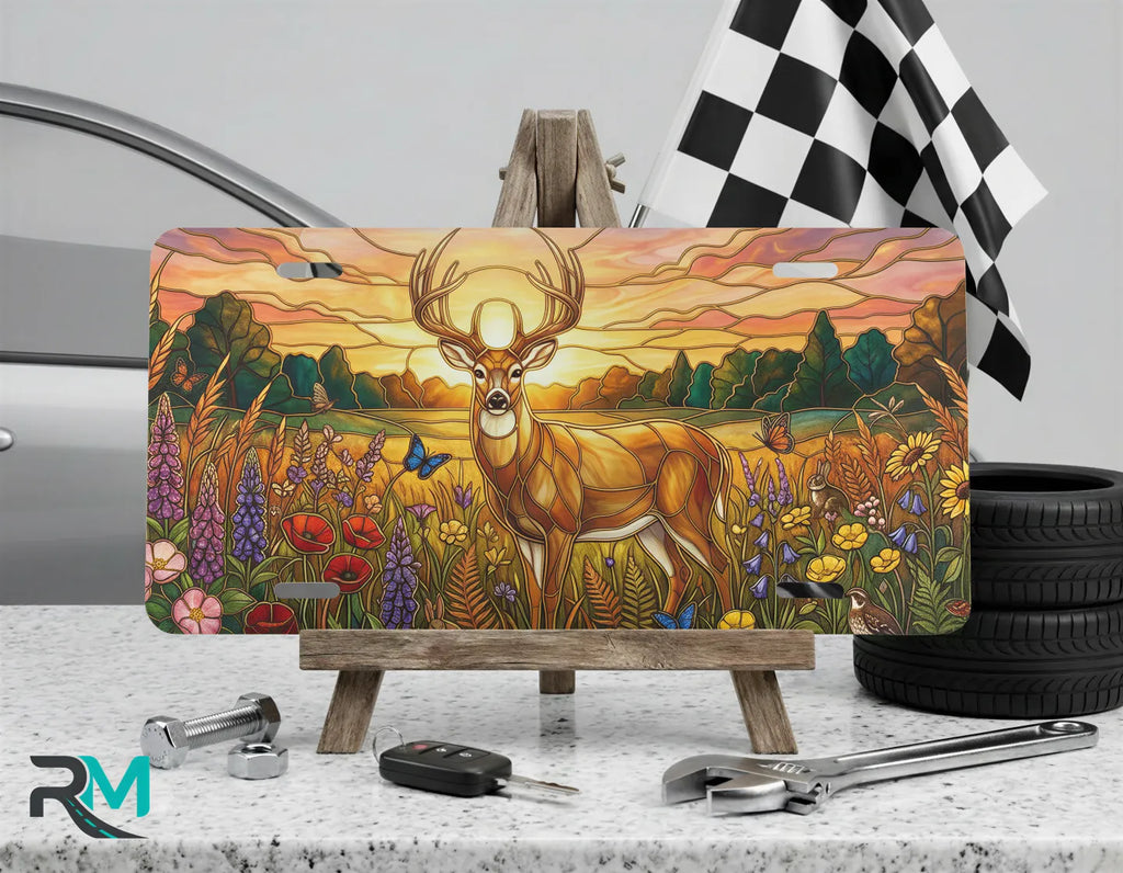 sunset deer vanity plate on display stand — warm amber wildflower buck aluminum plate