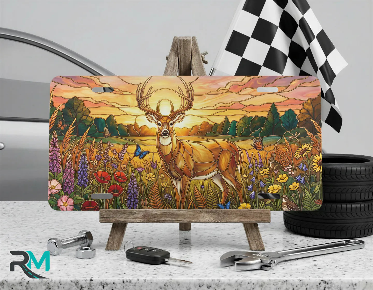 sunset deer vanity plate on display stand — warm amber wildflower buck aluminum plate