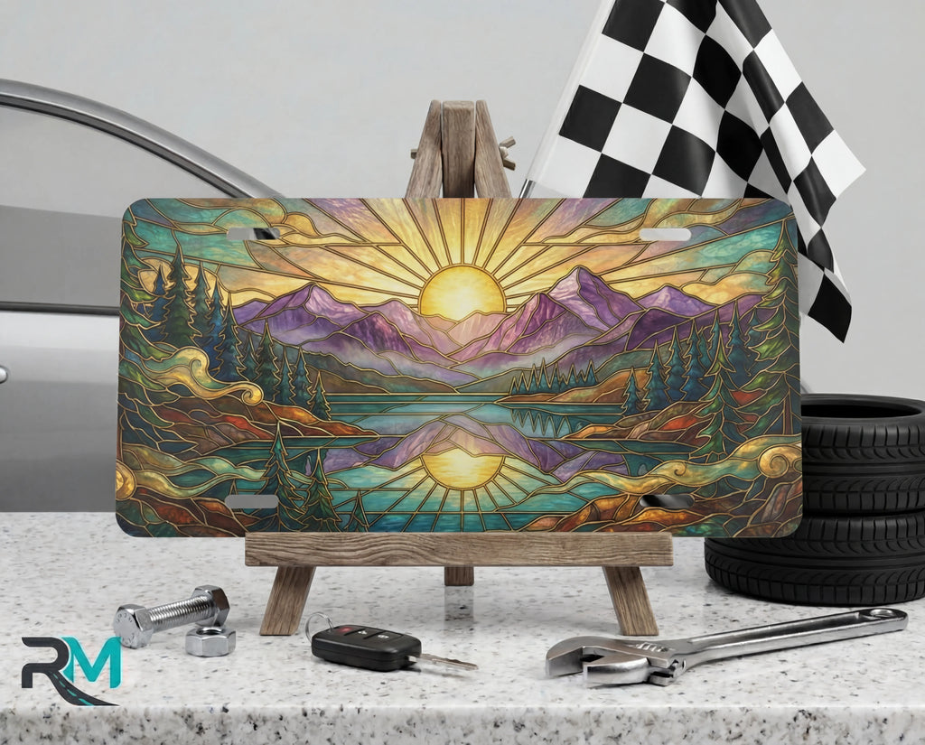 sunrise mountain lake scenic vanity plate on tire — warm gold purple mountain scenic front license plate