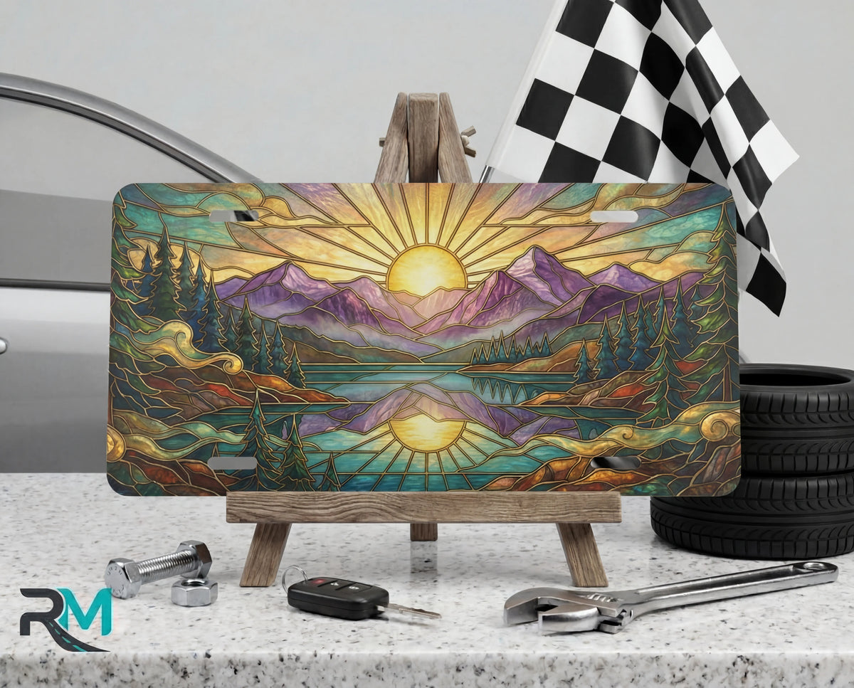 sunrise mountain lake scenic vanity plate on tire — warm gold purple mountain scenic front license plate