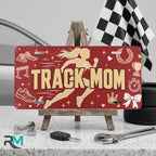 track mom vanity plate on display stand — runner silhouette spikes aluminum plate