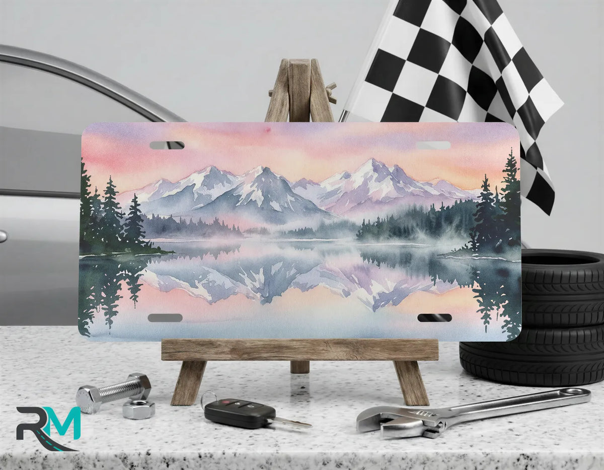 mountain lake vanity plate on display stand — blush pink evergreen reflection license plate