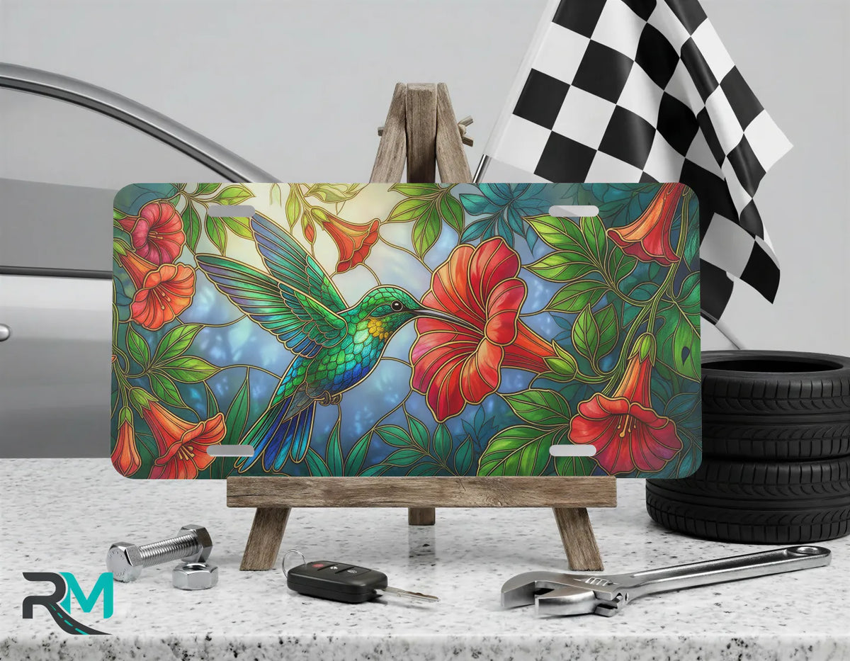 hummingbird hibiscus vanity plate on display stand — vivid red tropical bird aluminum plate