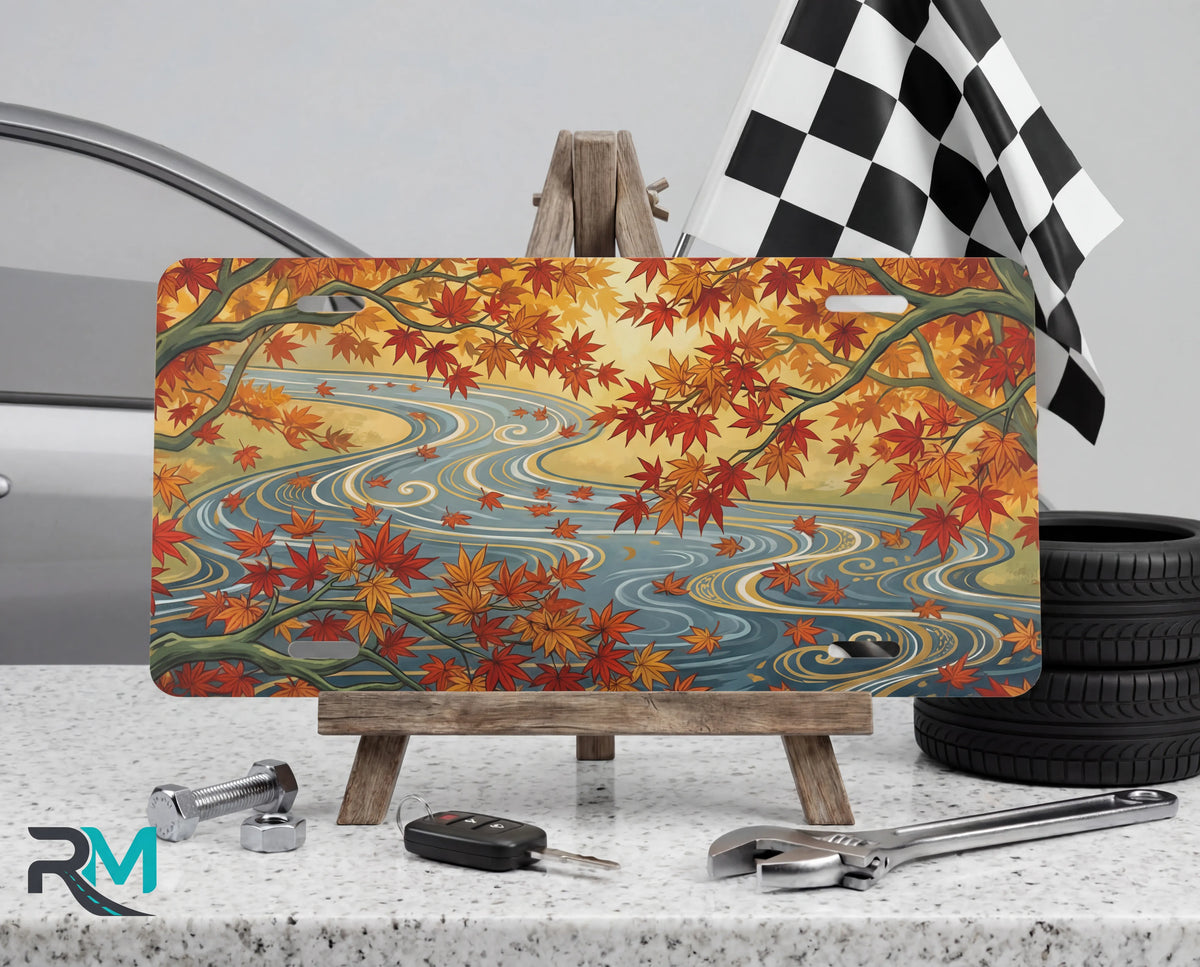 autumn maple stream vanity plate on tire — warm orange gold maple leaves autumn river front license plate