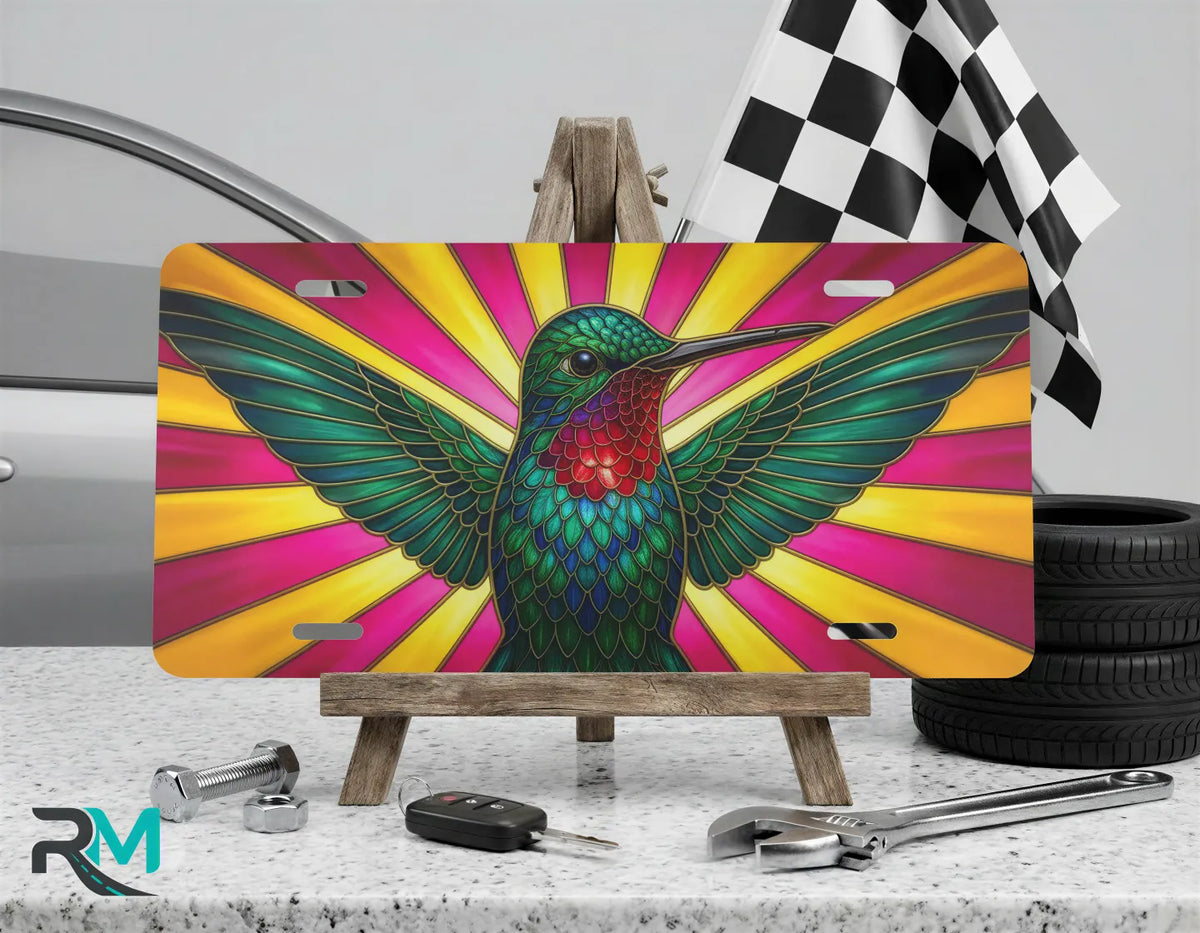 colorful hummingbird vanity plate on display stand — emerald sapphire gold bird aluminum plate