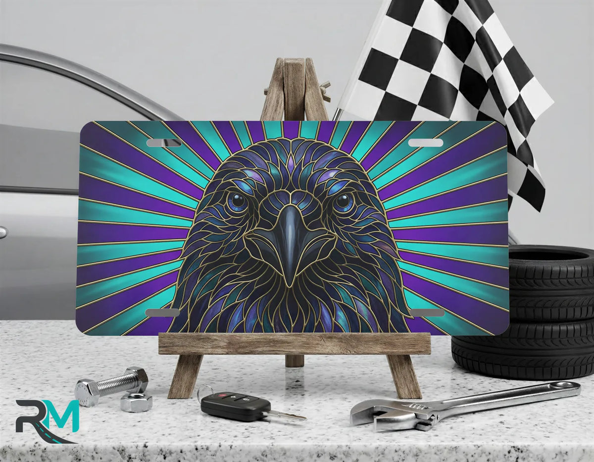 raven head radiant rays vanity plate on display stand — jewel-tone stained glass bird plate