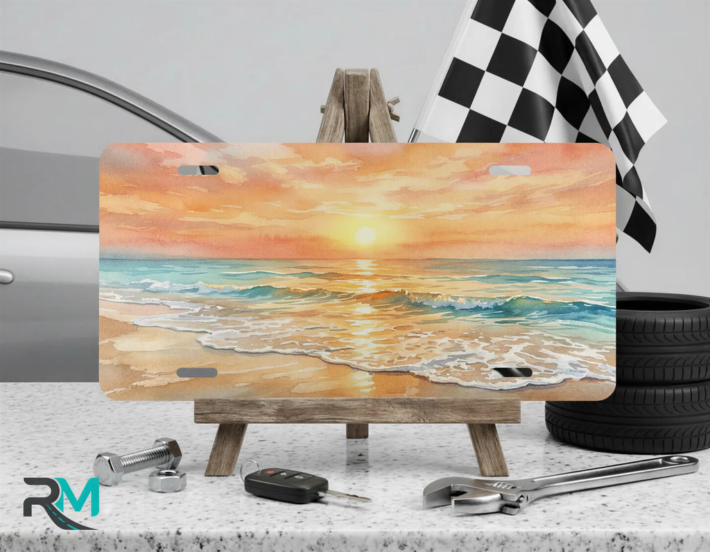 beach sunrise vanity plate on display stand — warm pink gold shoreline license plate