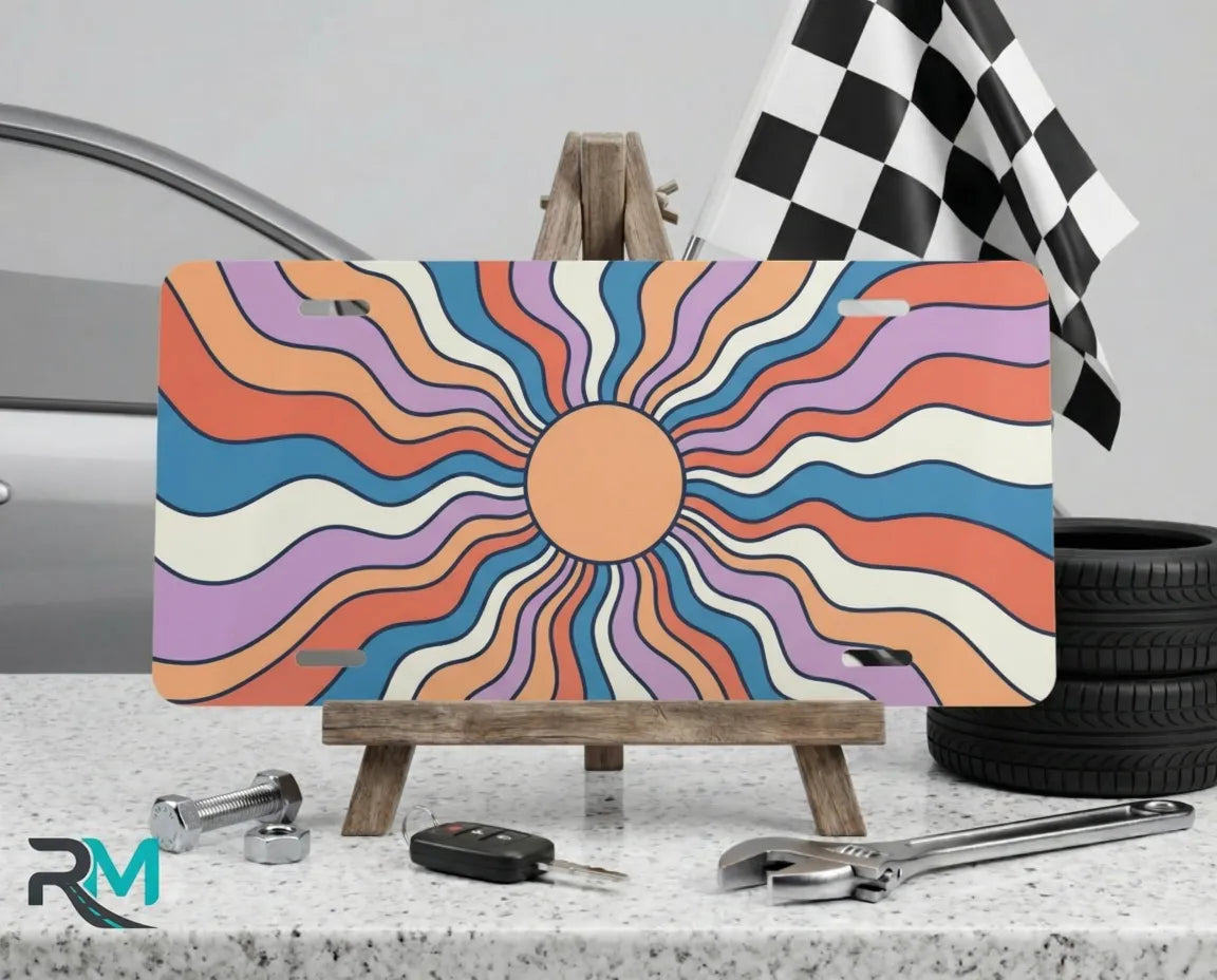 retro sun vanity plate on display stand — warm peach cream mauve aluminum license plate
