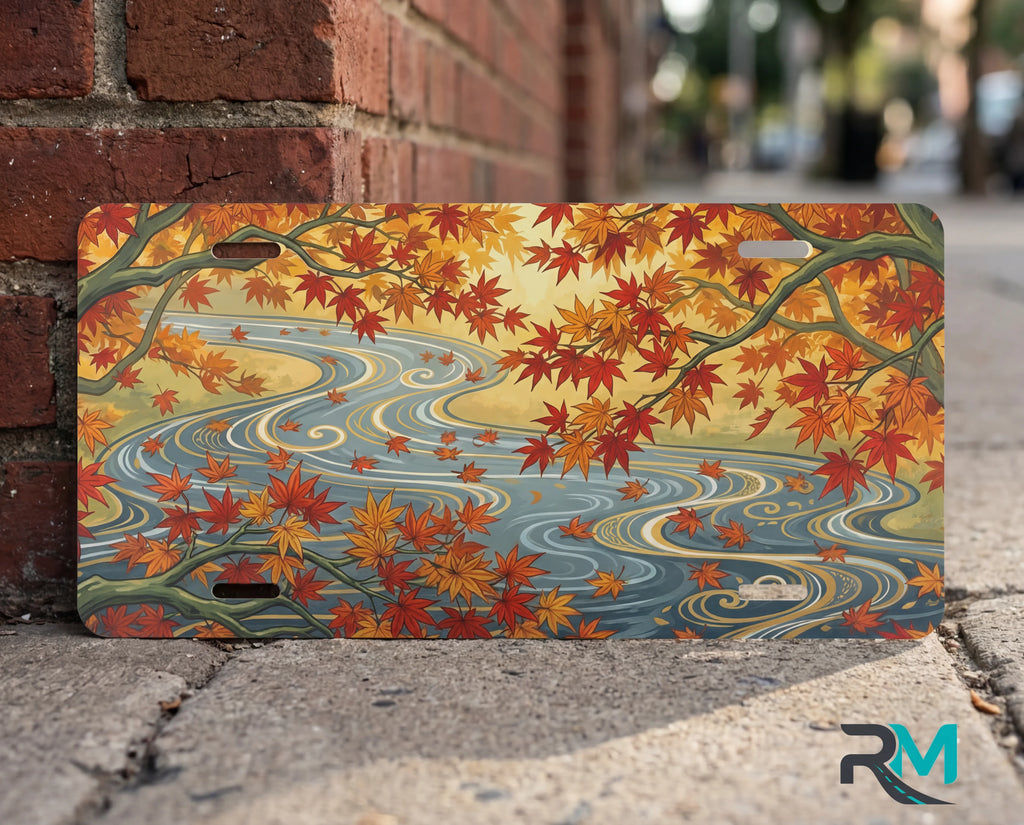 autumn maple stream vanity plate close up — warm orange gold maple leaves winding river autumn detail