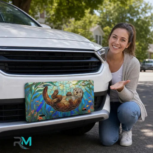 woman with sea otter stained glass vanity plate — jewel teal otter kelp front license plate