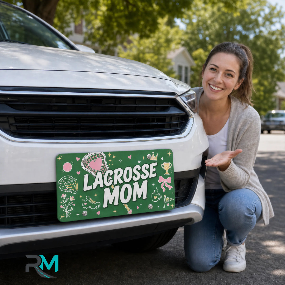 woman with lacrosse mom vanity plate — green pink lacrosse sticks front license plate