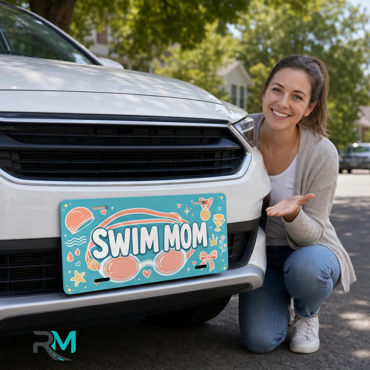 woman with swim mom vanity plate — teal coral SWIM MOM front license plate