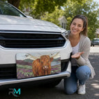 woman with highland cow vanity plate — warm ochre lavender pastoral front license plate